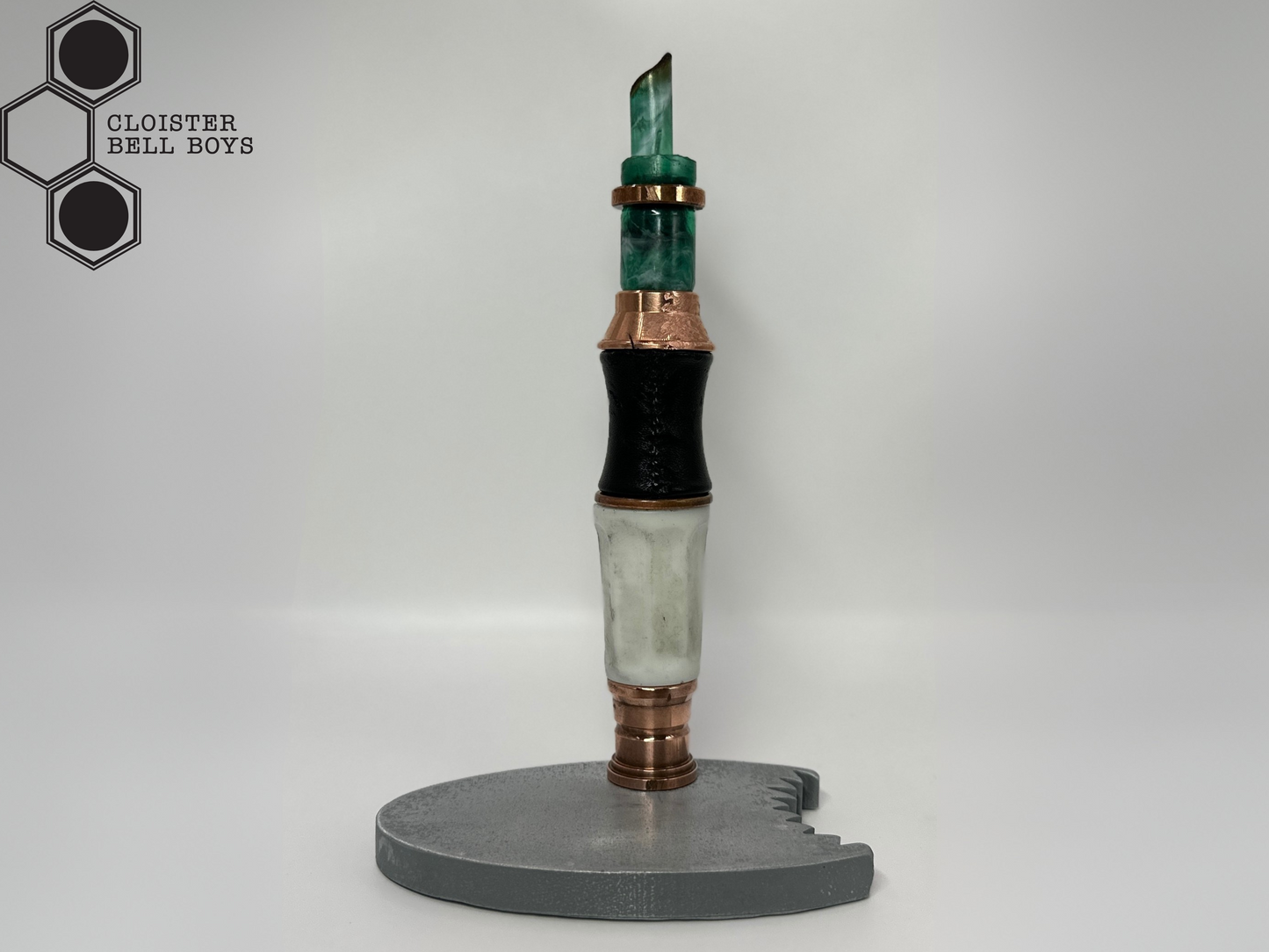 Shark-Bitten Screwdriver on a metallic gray stand against a white background, branded 'Cloister Bell Boys'.