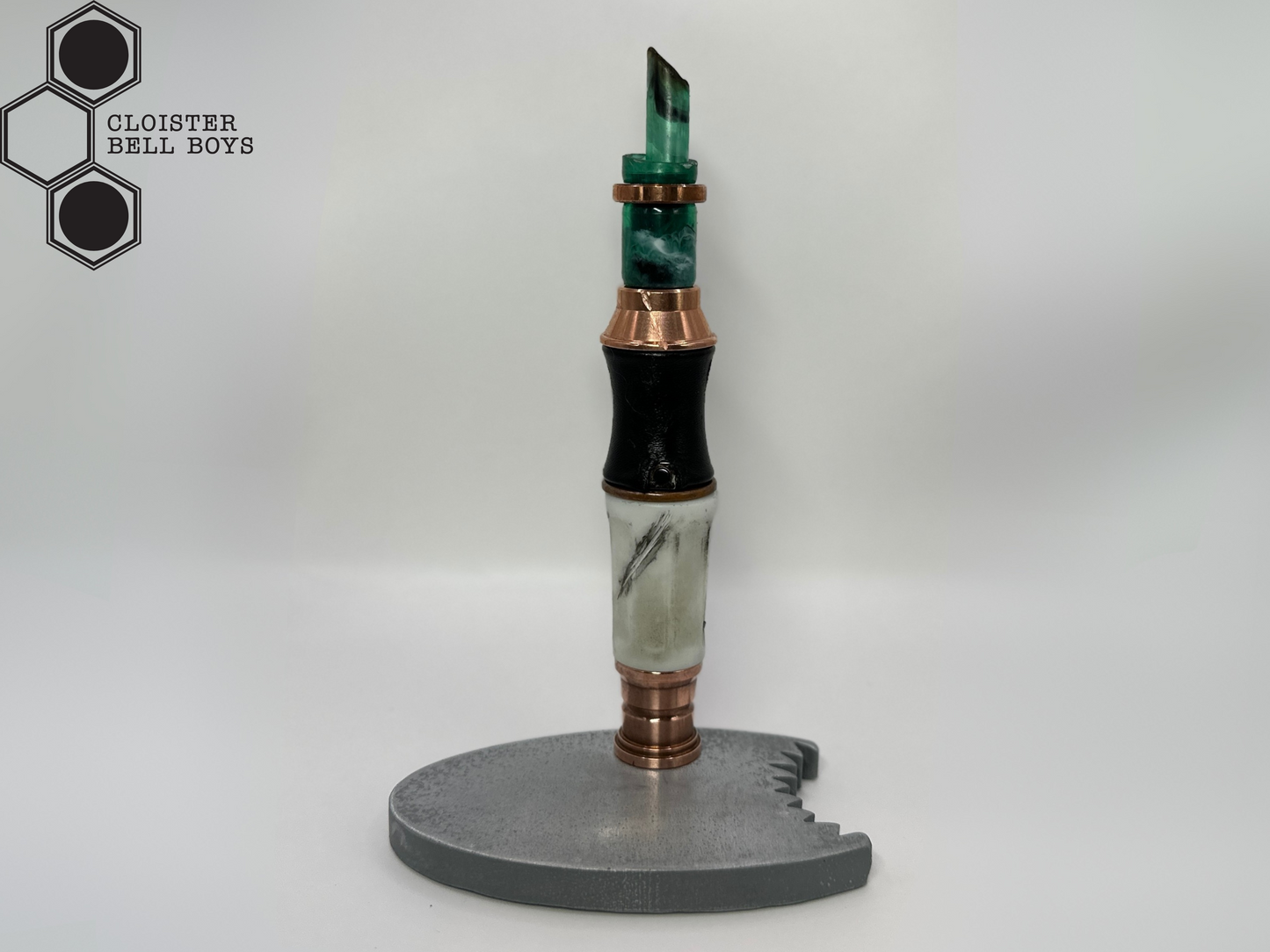 Shark-Bitten Screwdriver in a metallic gray stand against a white background, branded 'Cloister Bell Boys'.