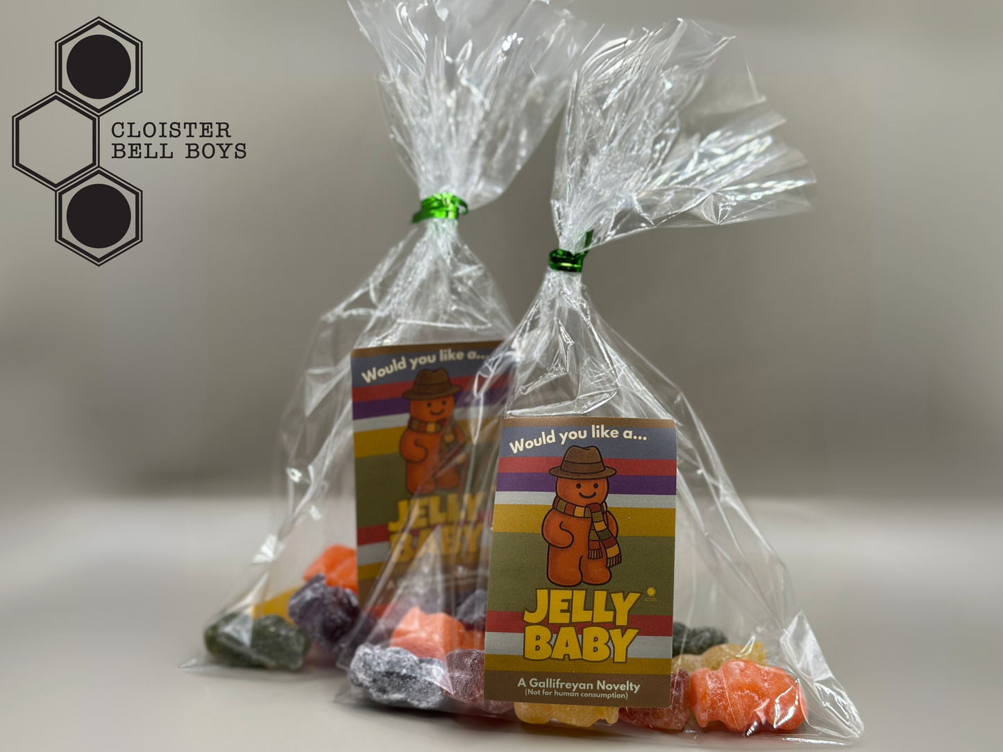 Two packages of resin Jelly Baby candy in clear cellophane bags on a light grey background.